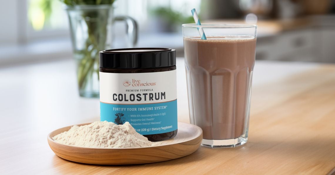 Live Conscious Colostrum sitting on kitchen counter with a chocolate smoothie next to it