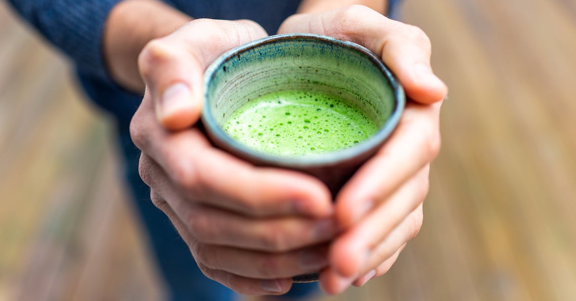 man holding matcha tea