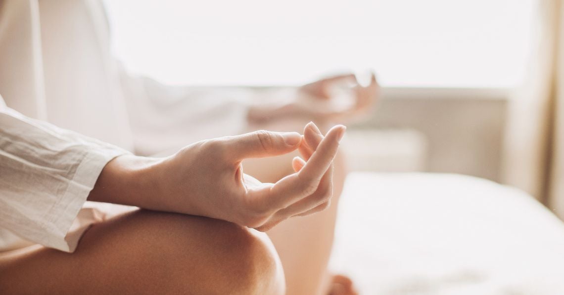 Woman meditating with hands on knees