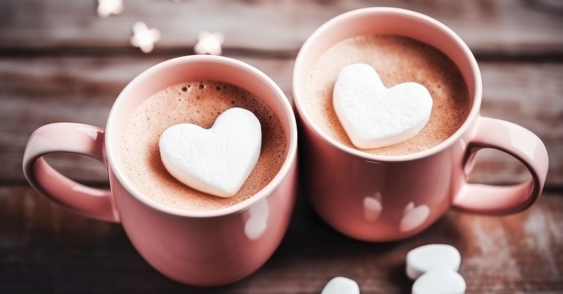 Two cups of hot cocoa with heart shaped marshmallows