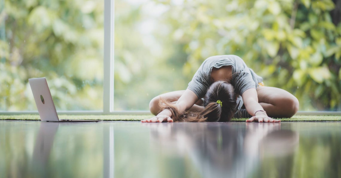 woman doing yoga at home