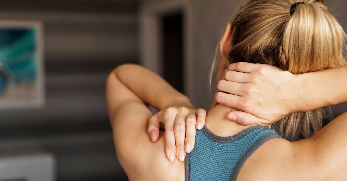 Woman massaging her neck and shoulder