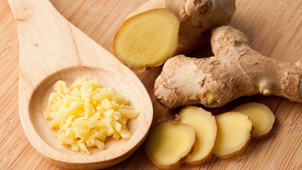 Ginger root sliced and chopped with wooden spoon
