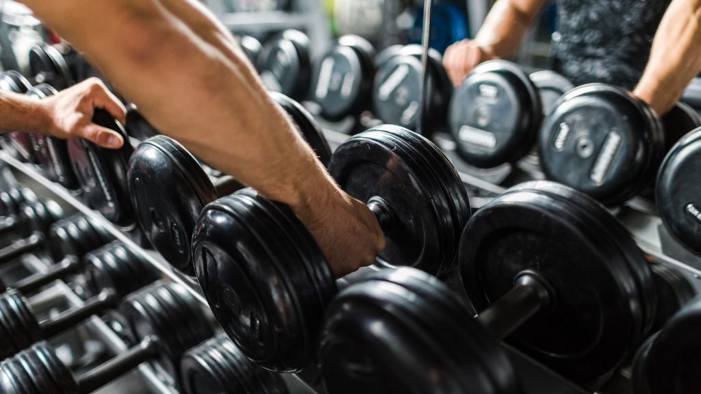 man grabbing a set of weights